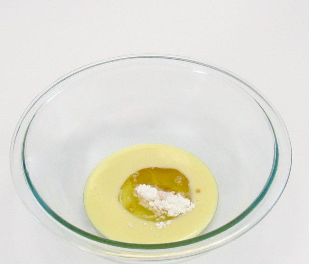 coconut macaroons wet ingredients in glass bowl