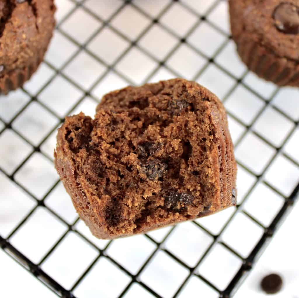 chocolate muffin on cooling rack with bite taken out