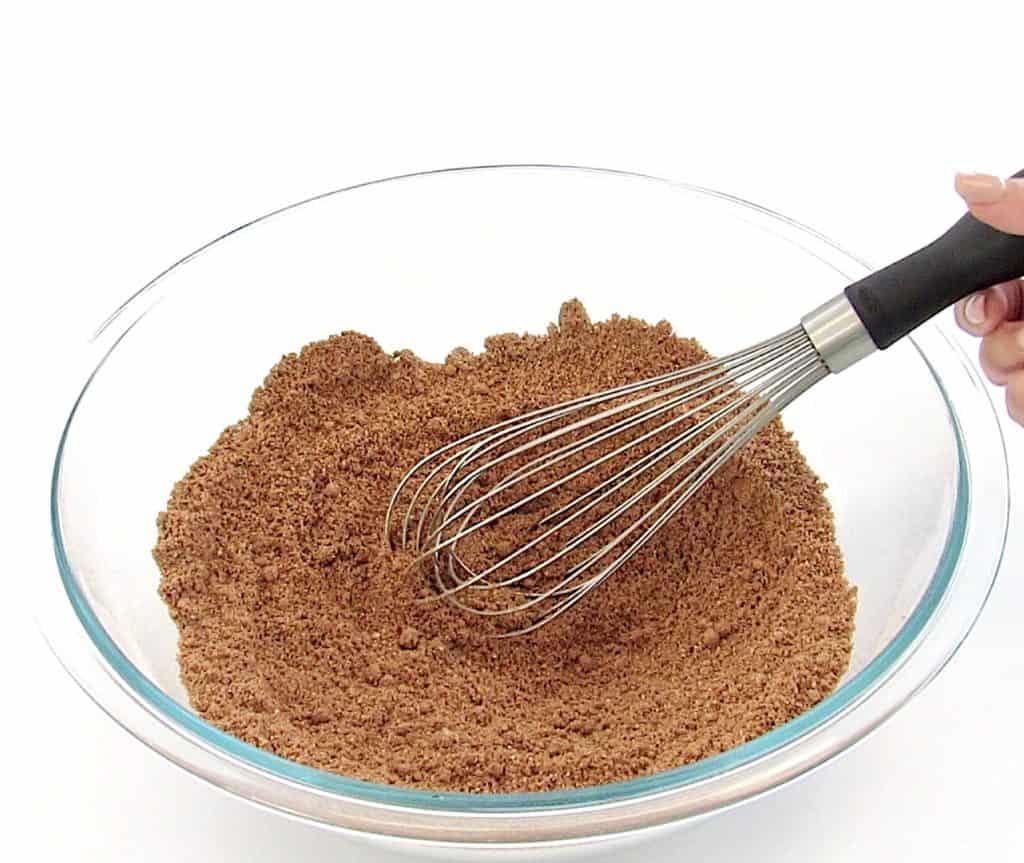 chocolate muffins dry ingredients in glass bowl with whisk