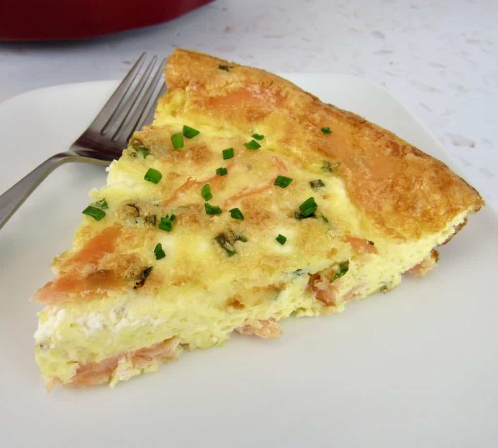 slice of salmon quiche with fork on plate