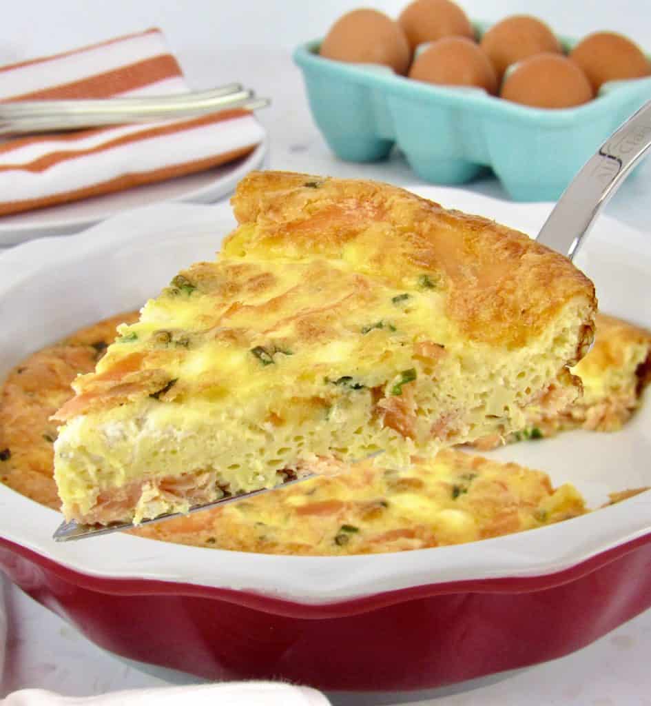 salmon crustless quiche with slice being held up with cake server
