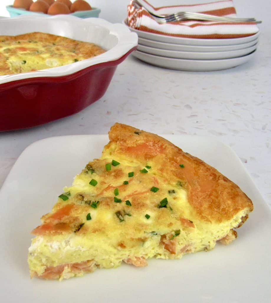 slice of crustless quiche on plate with pie plate in background