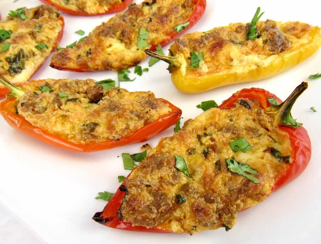 closeup of chorizo and cheese stuffed mini peppers on white plate