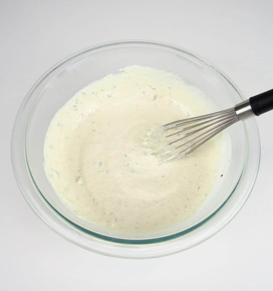 Creamy Horseradish Sauce ingredients in glass bowl mixed
