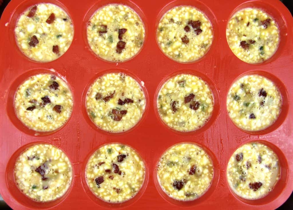 overhead view of unbaked Jalapeño Popper Egg Cups in red silicone pan