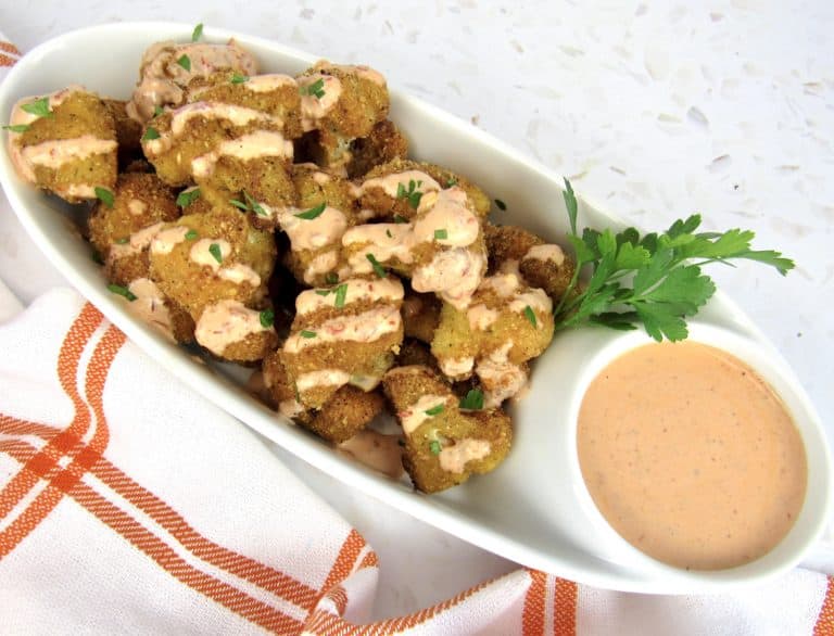 fried cauliflower with bang bang sauce drizzled on top