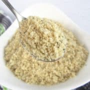 Keto Bread Crumbs in white bowl with spoon holding up some