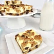 chocolate chip cookie bars on stand with one on plate