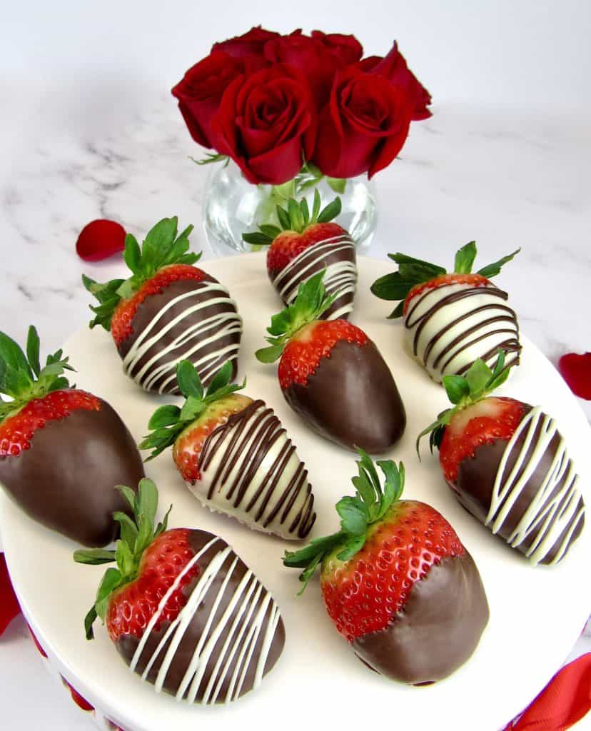 Chocolate Covered Strawberries in white plate with roses in background