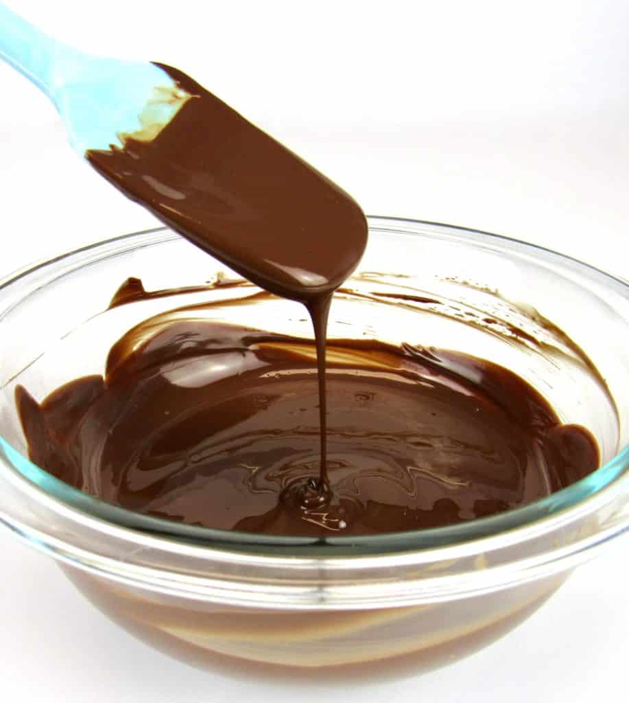 melted chocolate being drizzled by silicone spatula