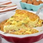 salmon crustless quiche with slice being held up