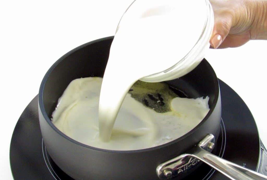 heavy cream being poured into pan
