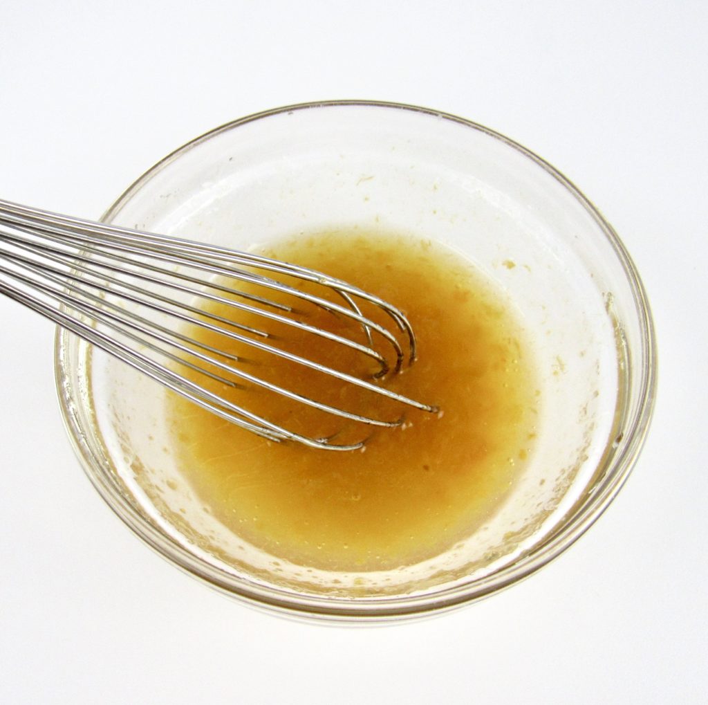 apricot glaze in glass bowl with whisk