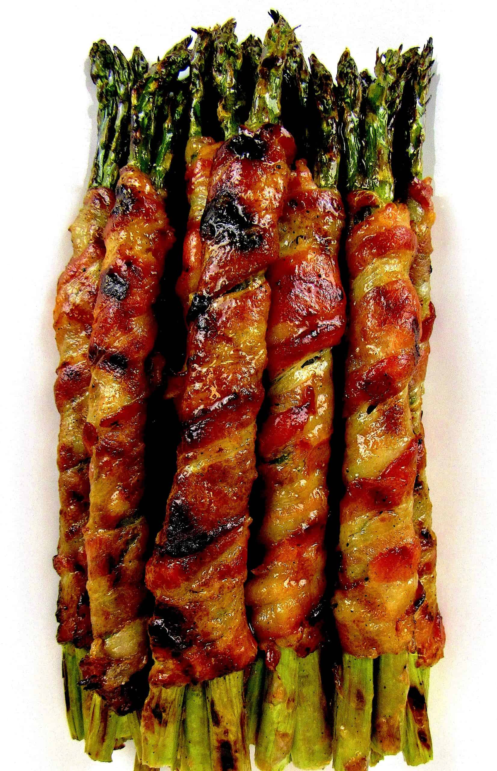 overhead view of Grilled Bacon Wrapped Asparagus on white plate