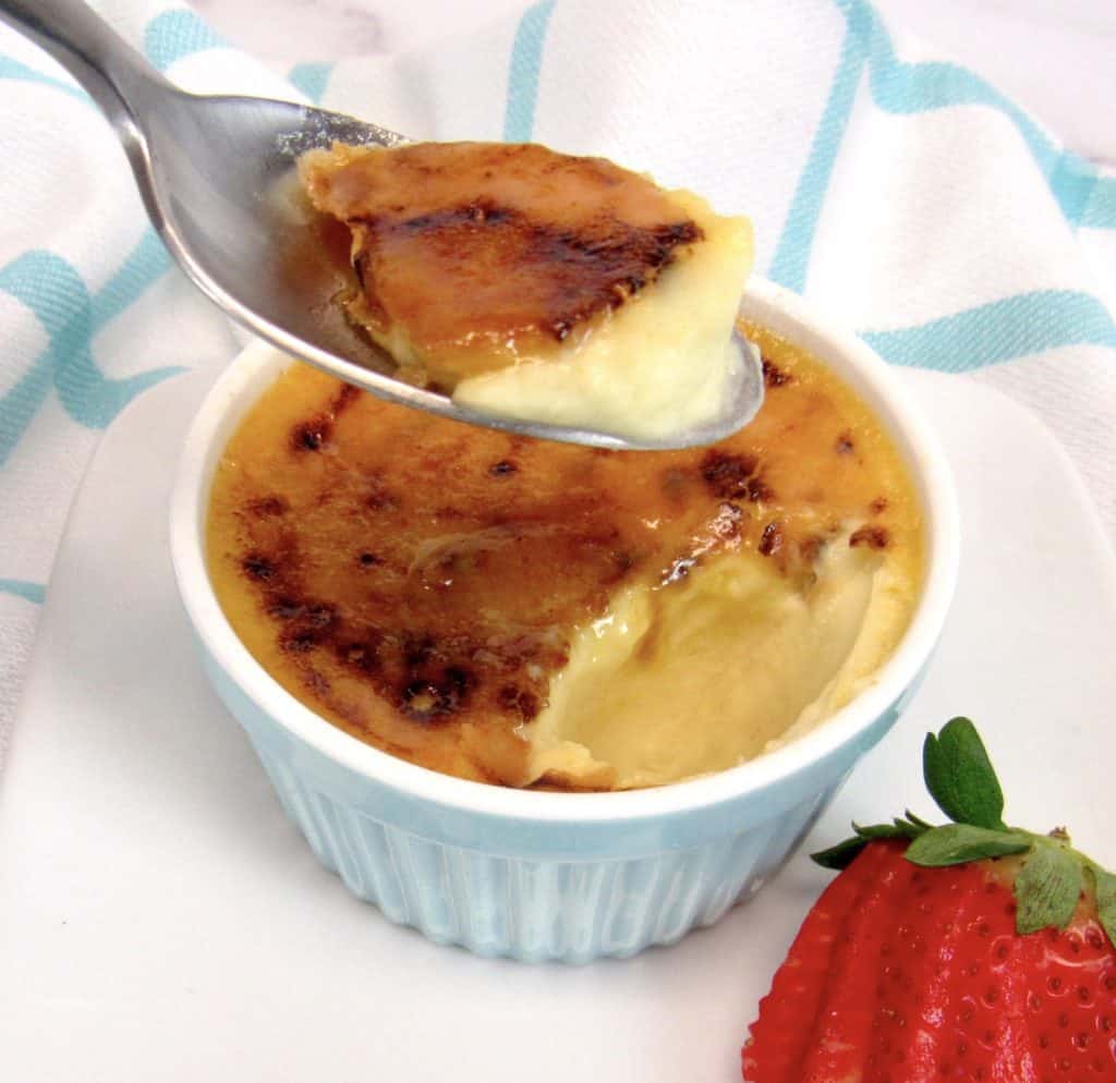 Keto Creme Brûlée with spoonful held up