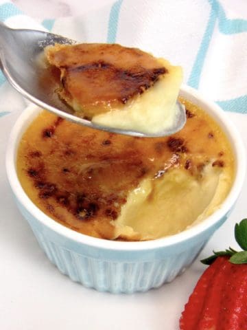 Keto Creme Brûlée with spoonful held up