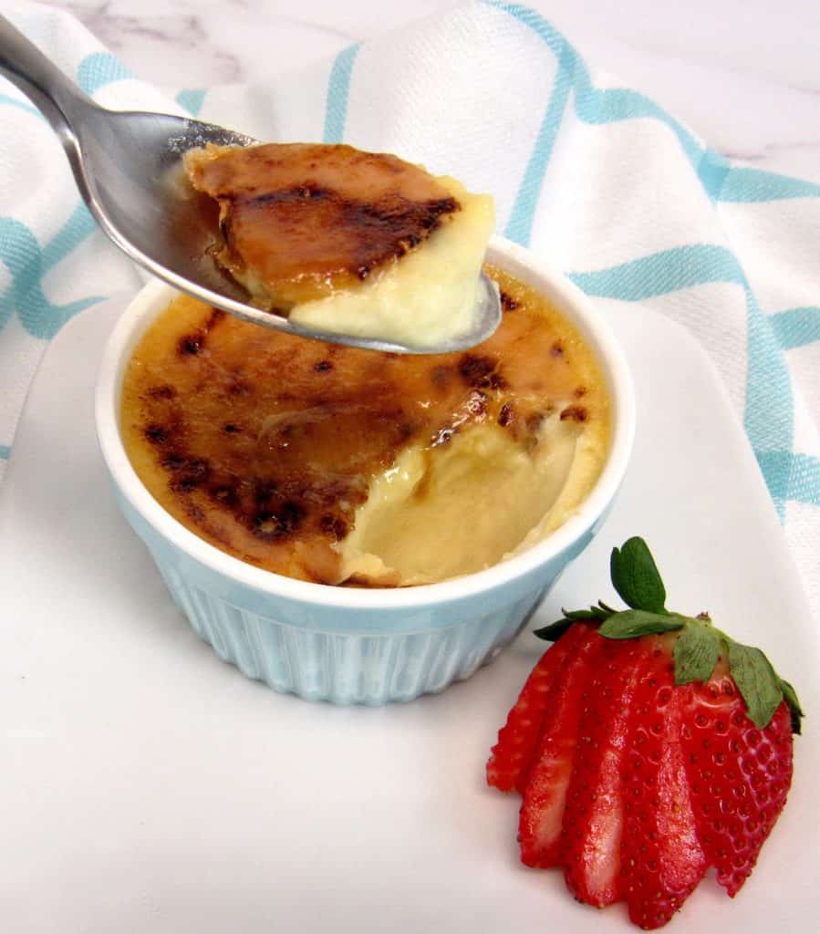 Keto Creme Brûlée with spoon holding up some