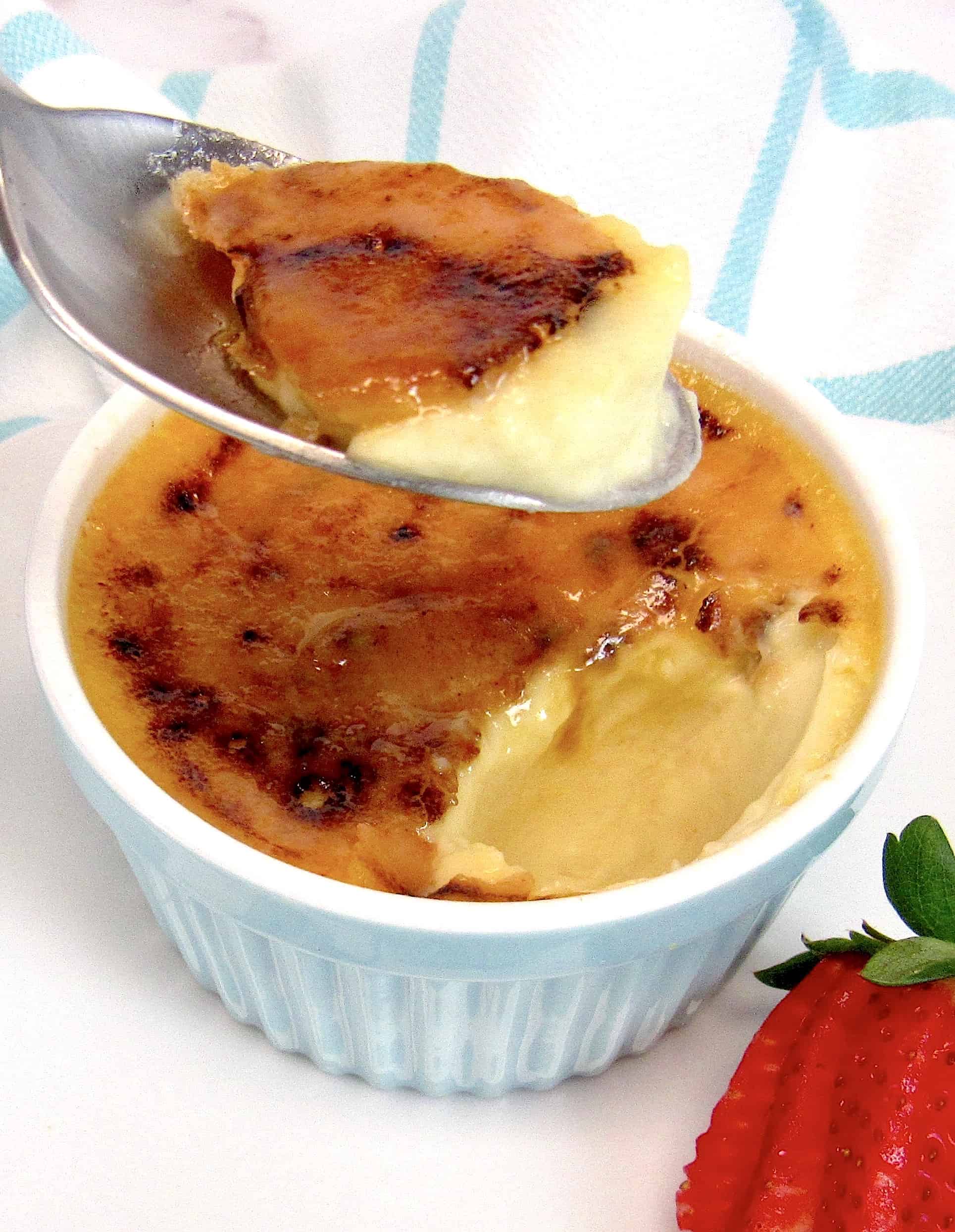 Keto Creme Brûlée with spoon holding up some