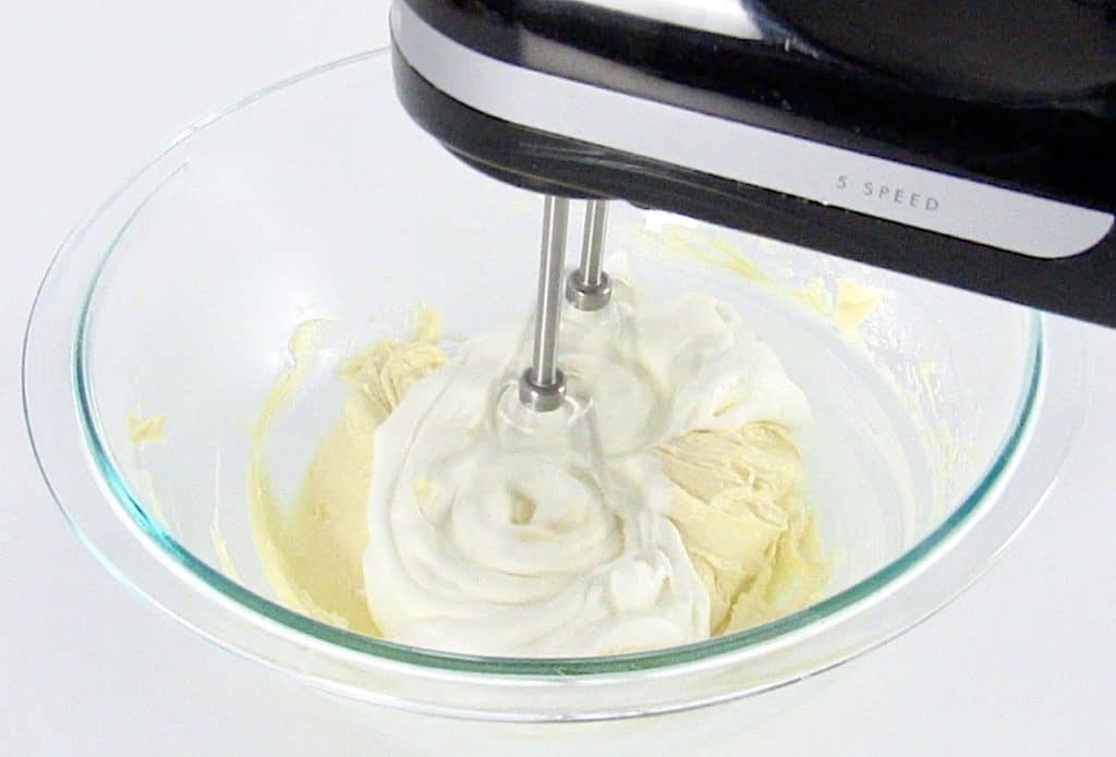 butter and sour cream being mixed in glass bowl