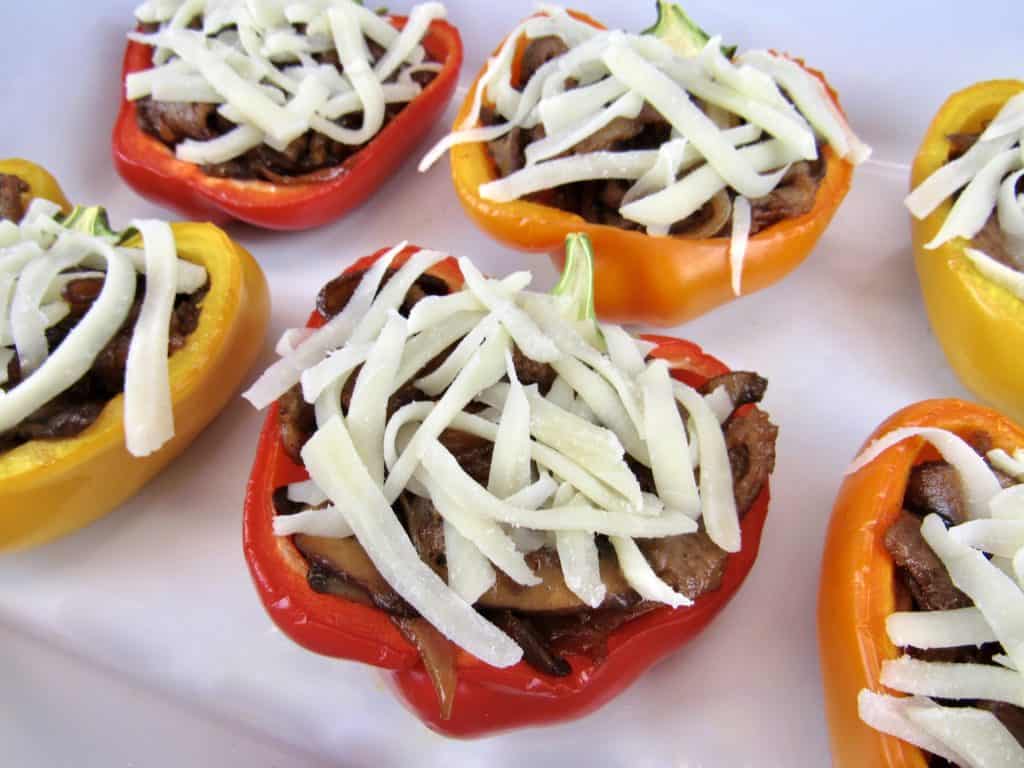 stuffed peppers with shredded cheese on top