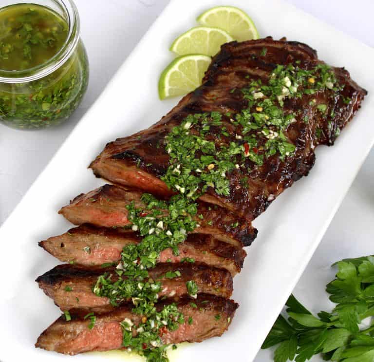 grilled skirt steak sliced with chimichurri sauce on top