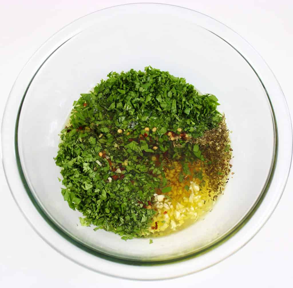 chimichurri sauce ingredients in glass bowl