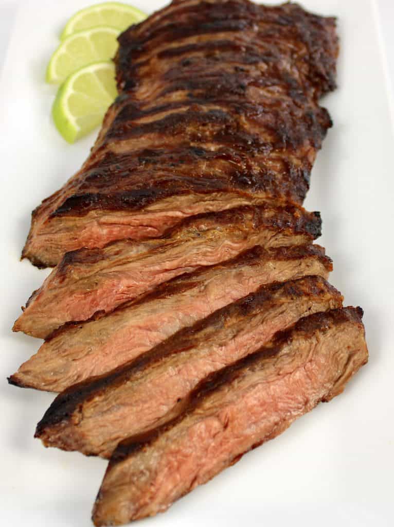 sliced skirt steak on white plate