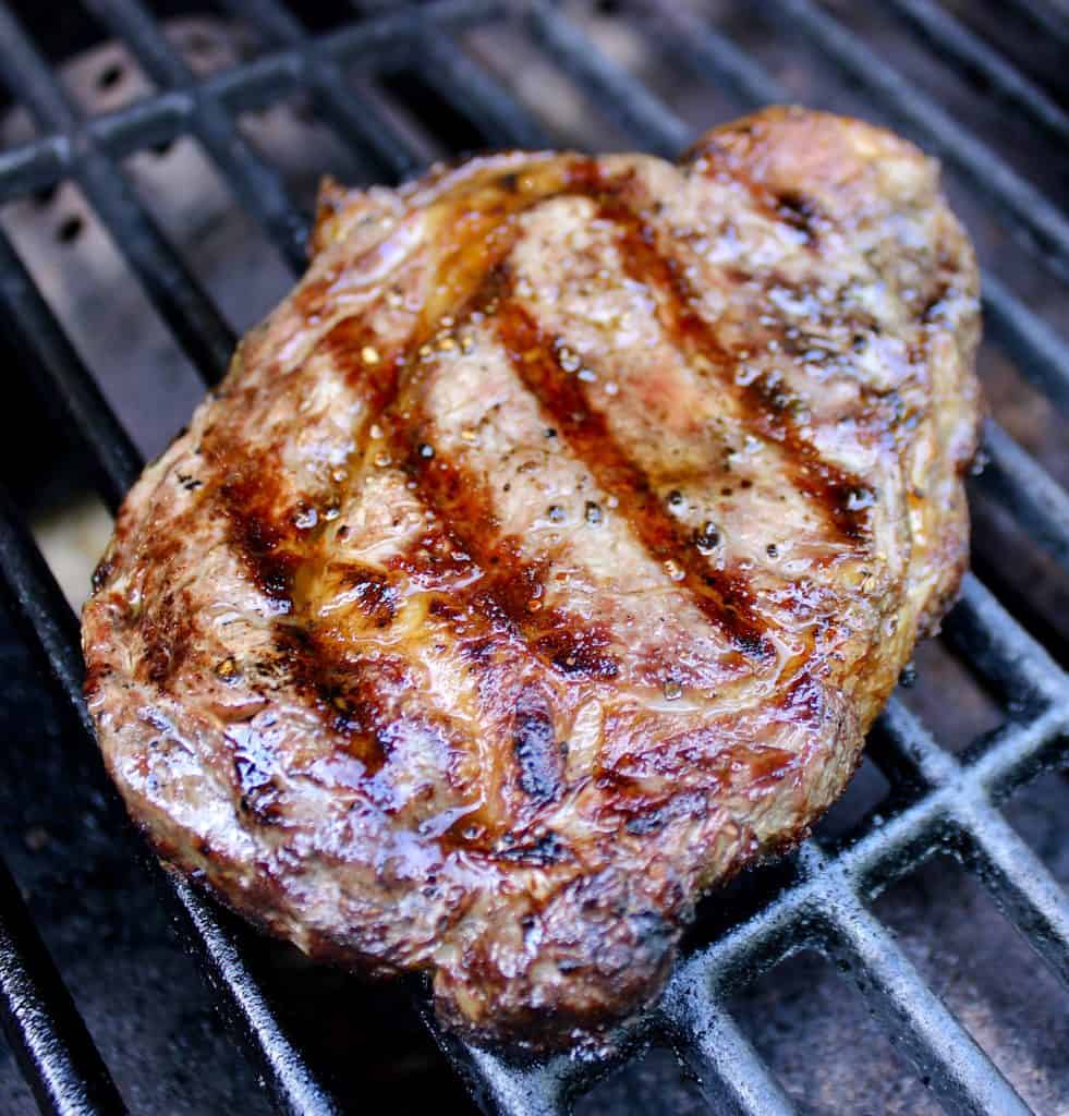 cooked ribeye steak on grill