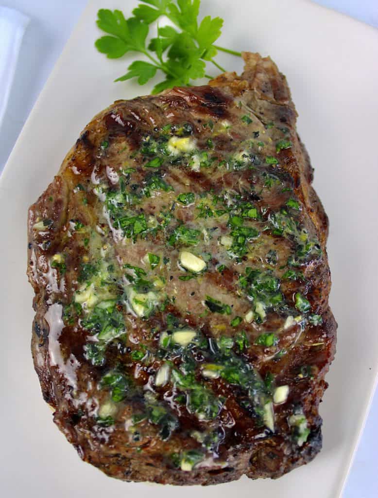 grilled ribeye steak with melted compound butter on top