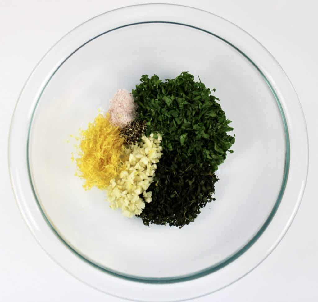 herbs lemon zest and garlic in glass bowl