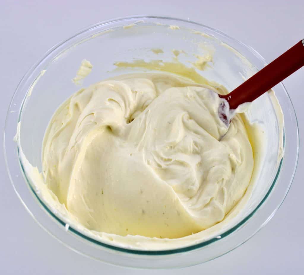 key lime cheesecake filling in glass bowl with red spatula