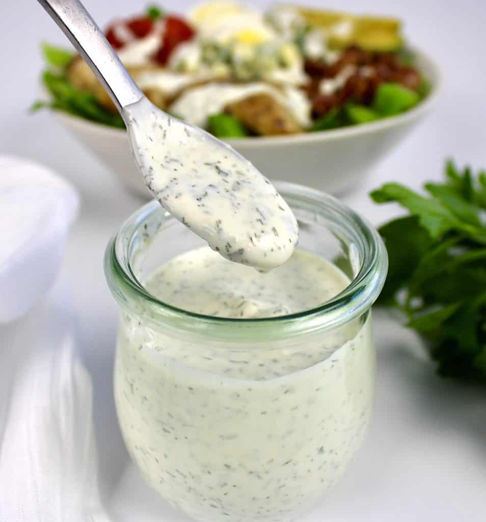 keto ranch dressing being spooned out of glass jar