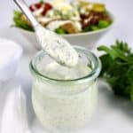 keto ranch dressing being spooned out of glass jar