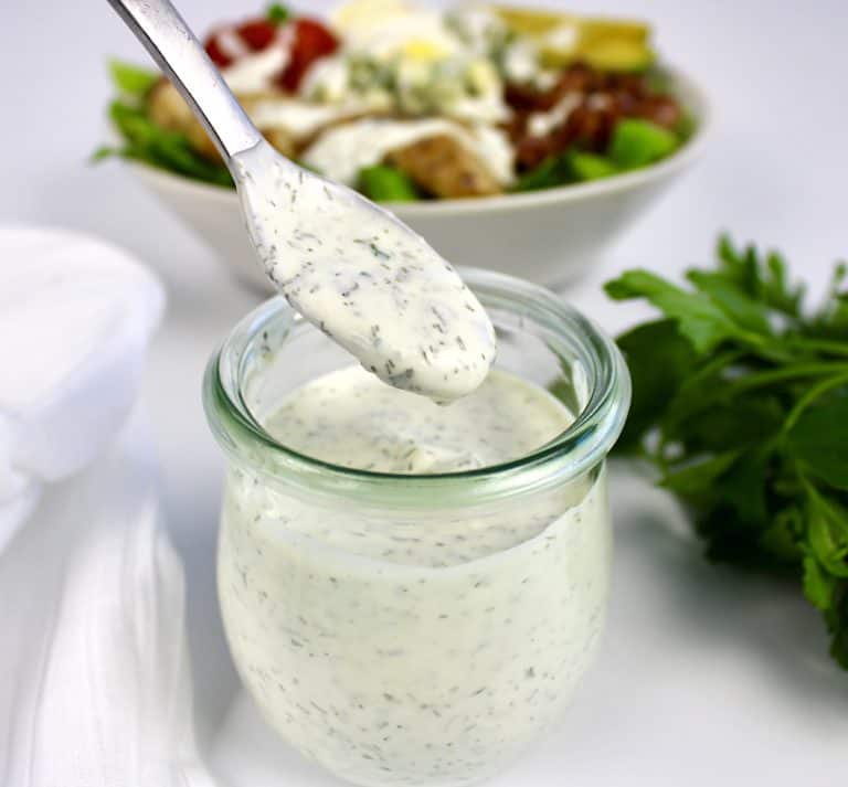 keto ranch dressing being spooned out of glass jar