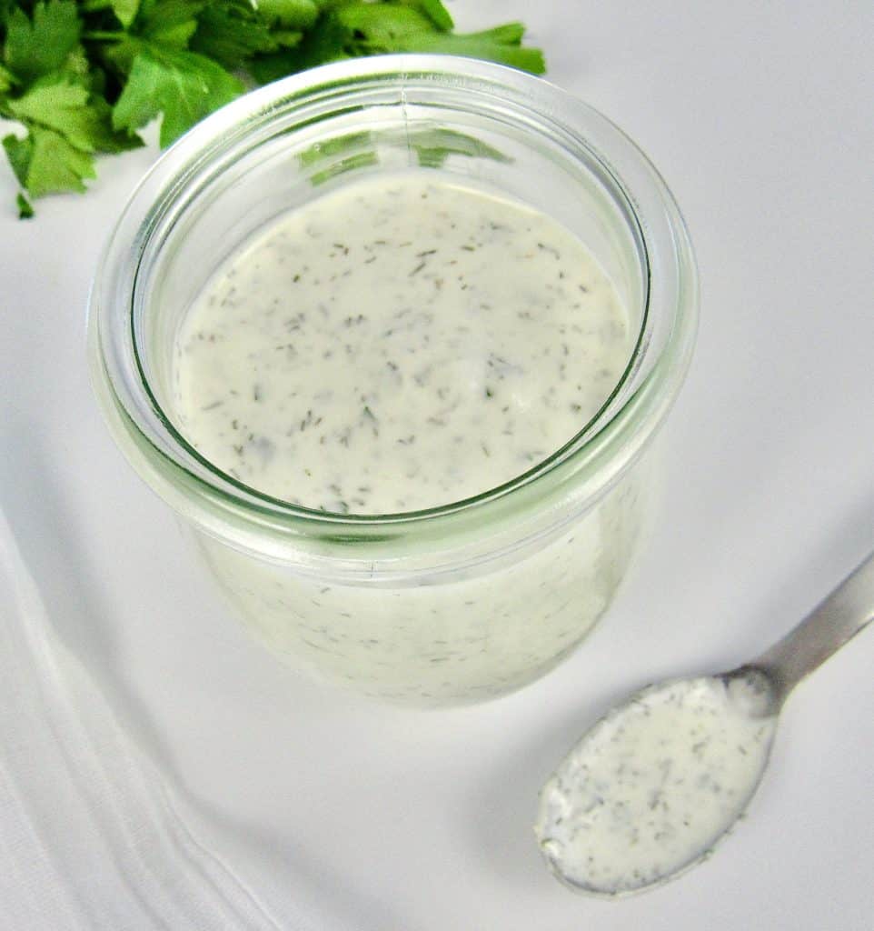 ranch dressing in glass jar with spoon on side