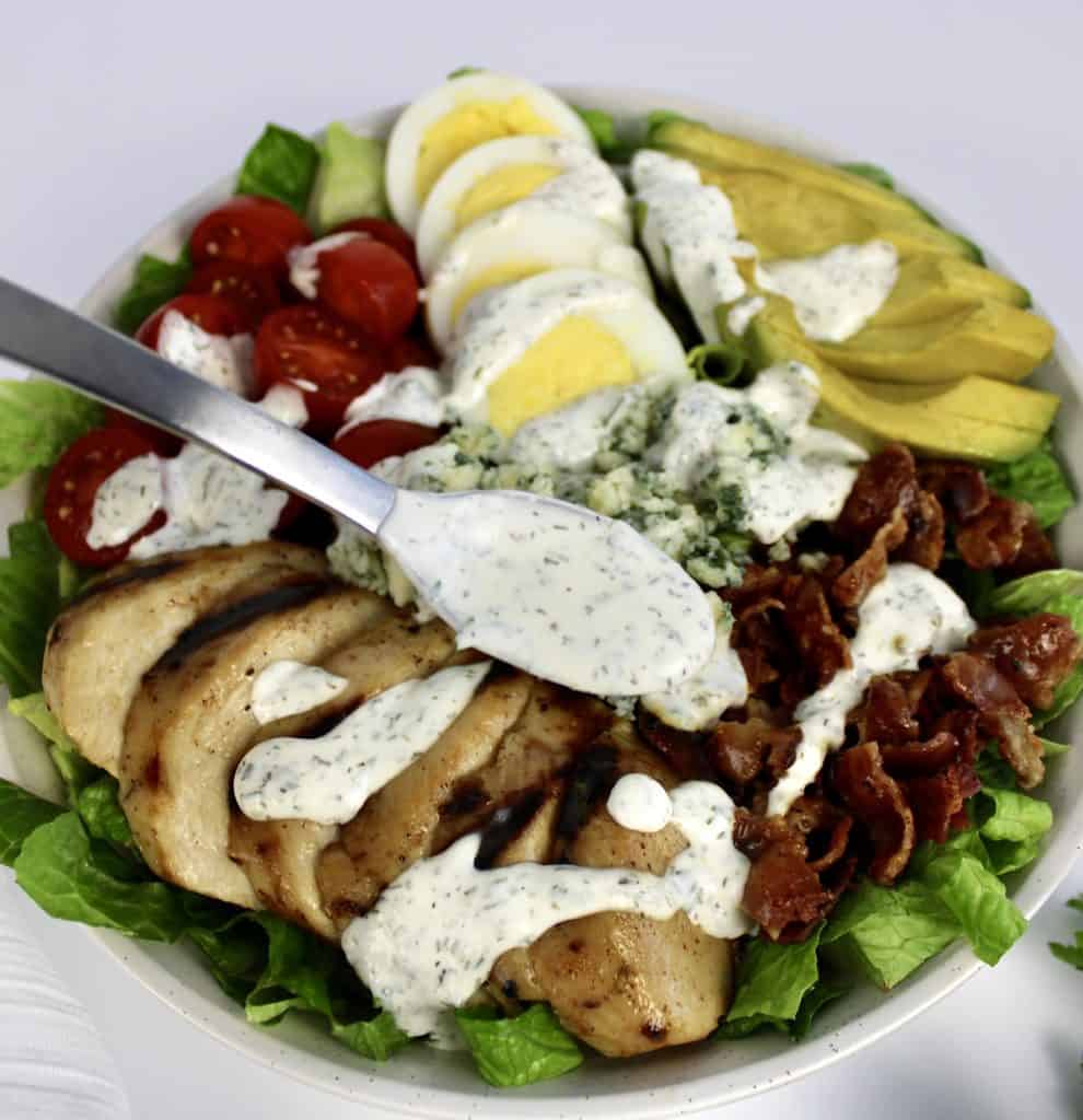 keto ranch dressing being spooned over cobb salad