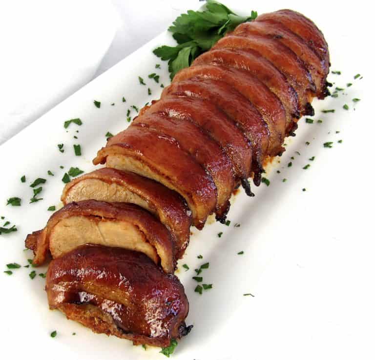 Bacon Wrapped Pork Tenderloin on white plate sliced