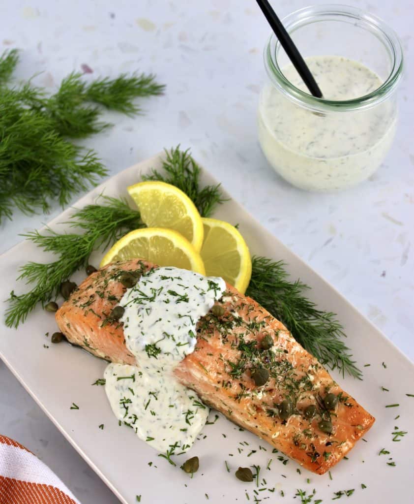 Baked Salmon with Creamy Dill Sauce in background