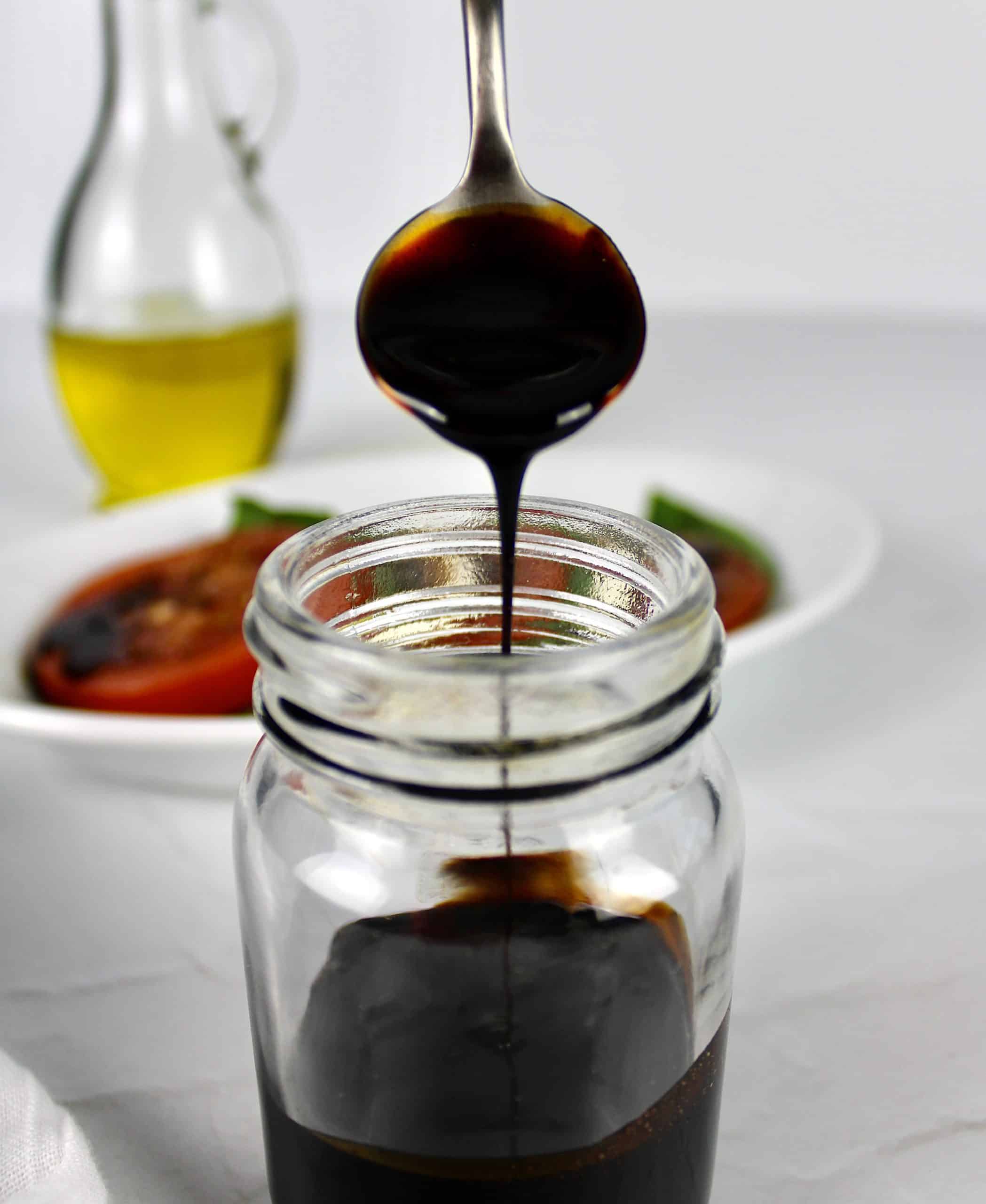 Balsamic Reduction dripping off spoon in jar