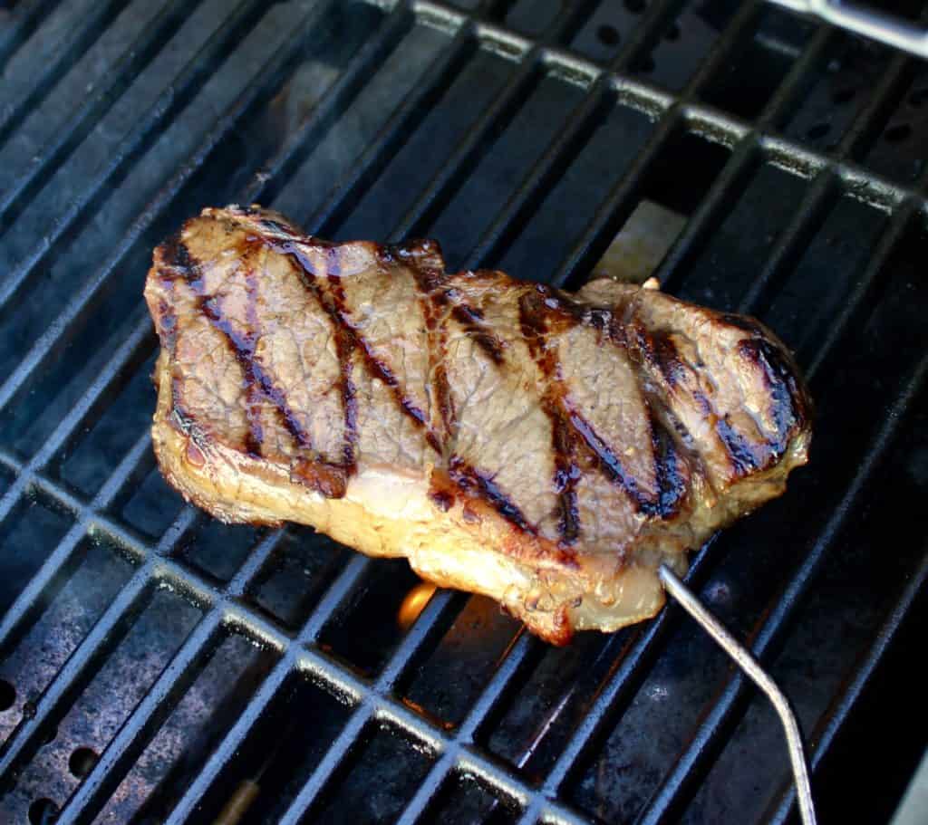 steak on the grill with meat thermometer
