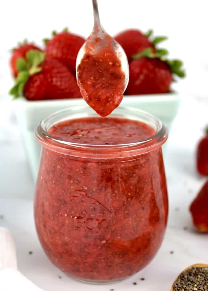 Keto Strawberry Chia Seed Jam being spooned out of glass jar