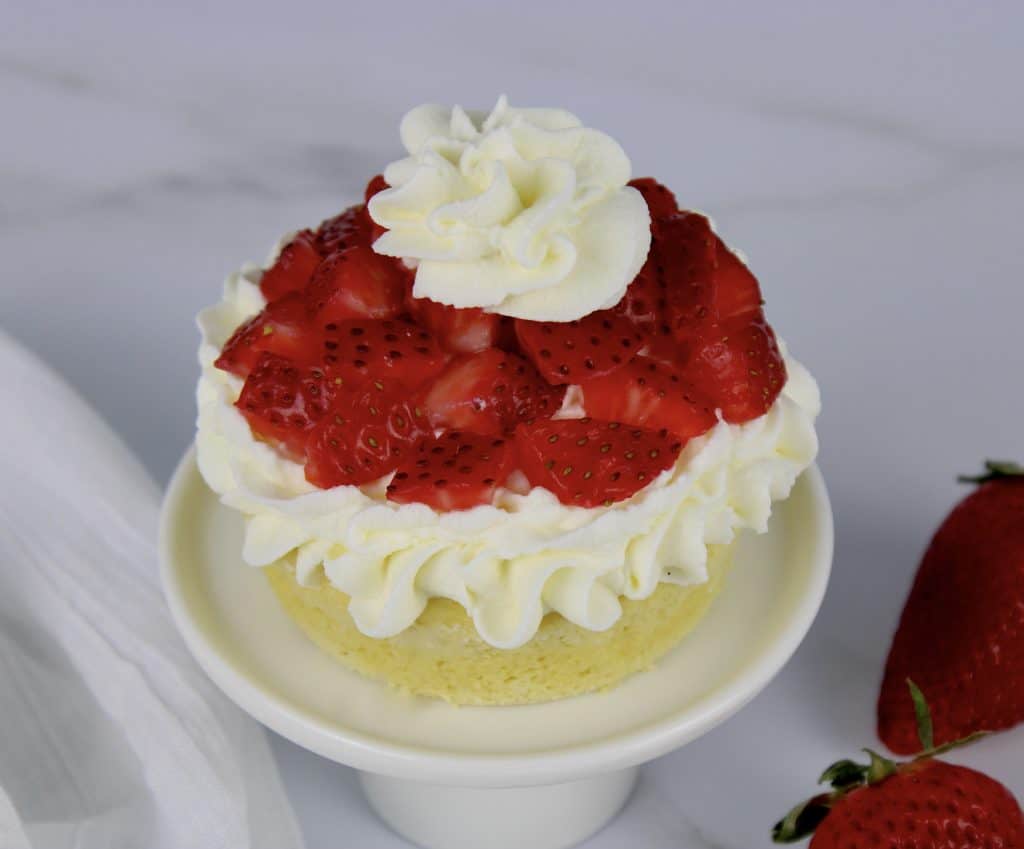 Strawberry Shortcake Keto Mug Cake with whip cream on top