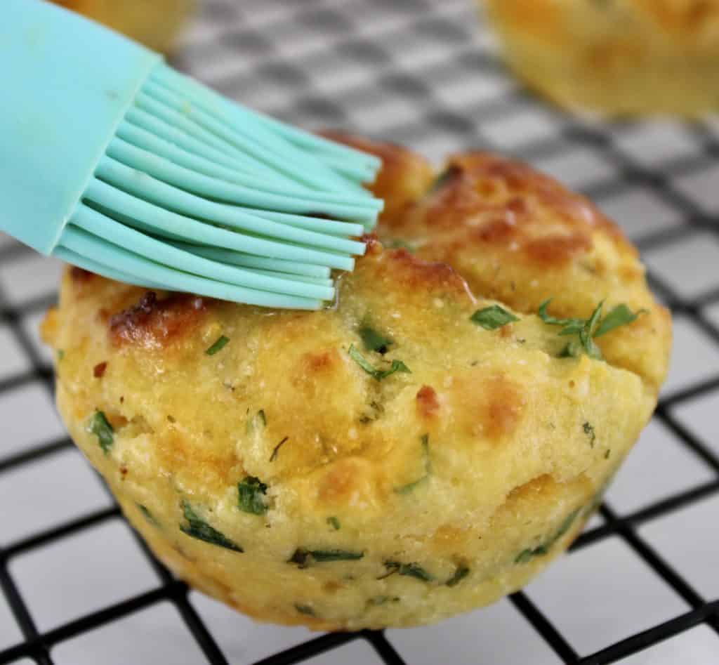 Cheddar Ranch Keto Biscuits with butter being brushed on top