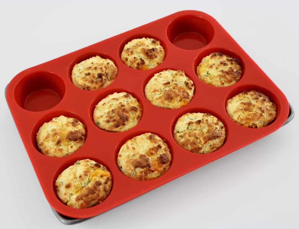 Cheddar Ranch Keto Biscuits in red muffin pan