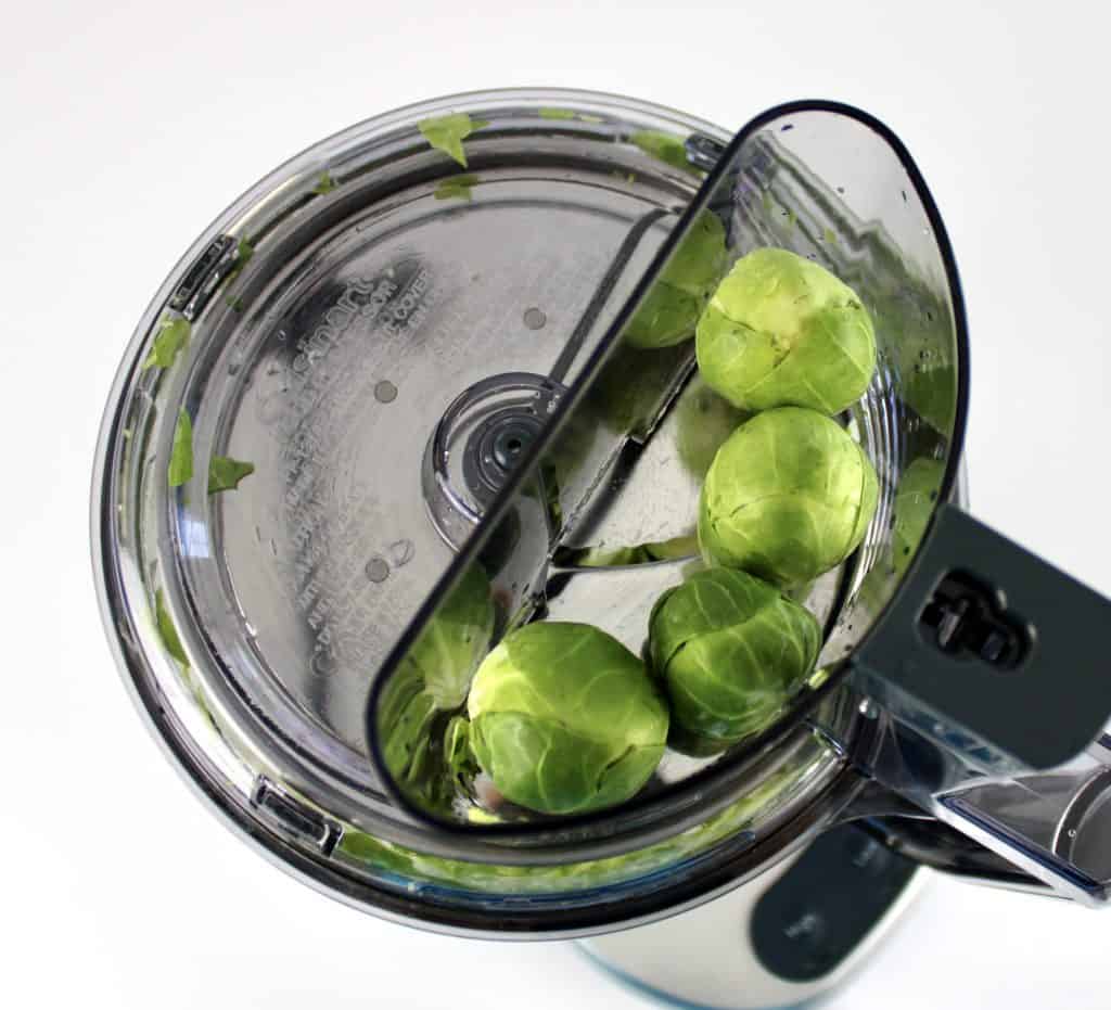 4 brussels sprouts in feed chute of food processor