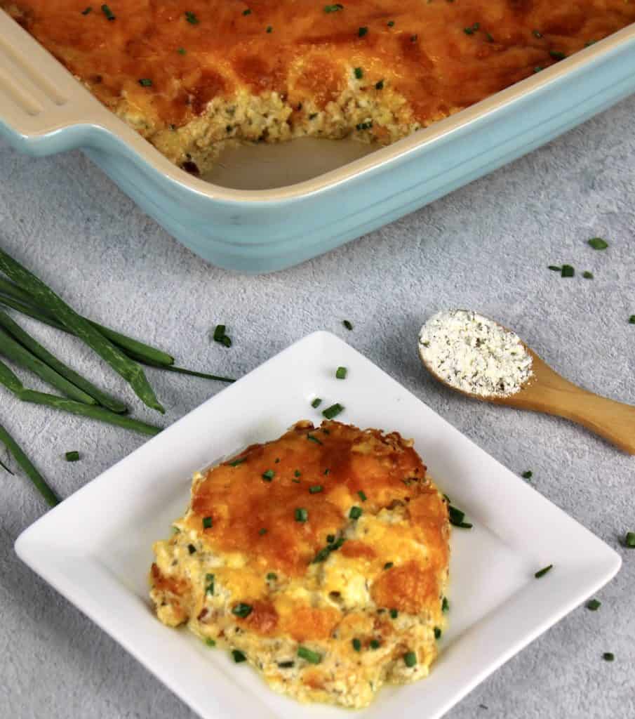 Ranch Roasted Cauliflower Casserole slice on white plate with casserole in background