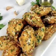 Air Fryer Garlic Parmesan Wings on white platter with parsley on top
