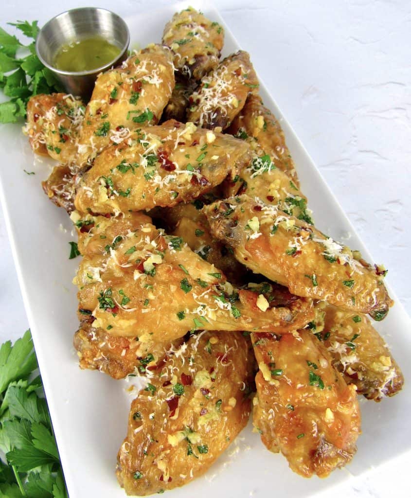 Air Fryer Garlic Parmesan Wings on white platter with parsley on top