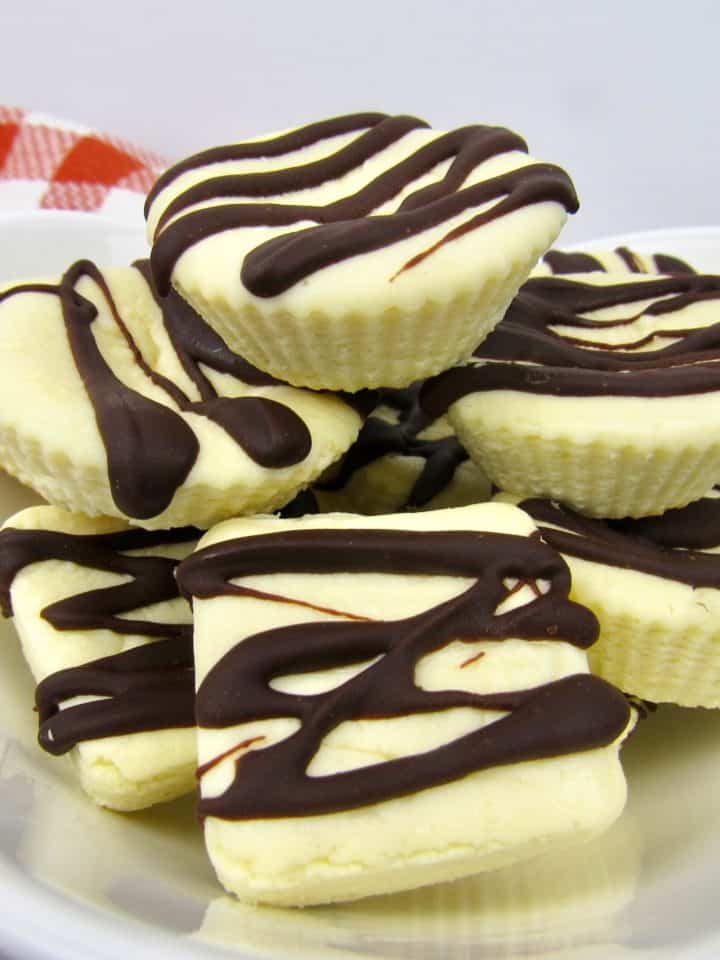 Cheesecake Fat Bombs drizzled with chocolate piled up