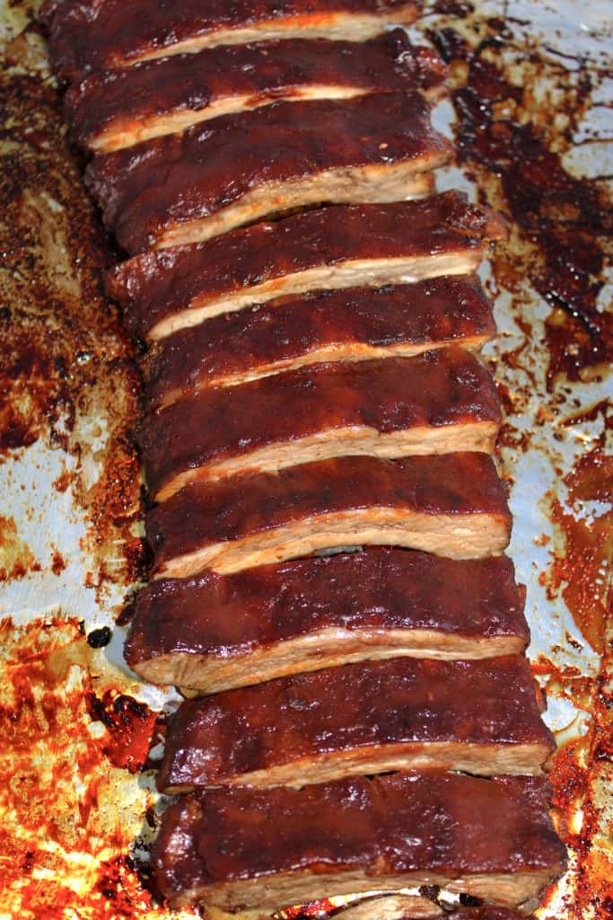 baked bbq rack of ribs on baking sheet